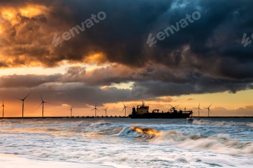 Preview: big ship on North sea waves at sunrise