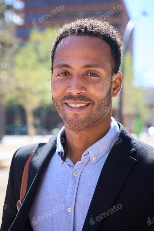 Preview: Vertical portrait of young adult Latino business man with happy expression. Commercial male formal.