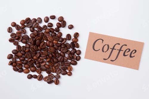 Preview: Coffee Beans and Coffee Label on White Surface
