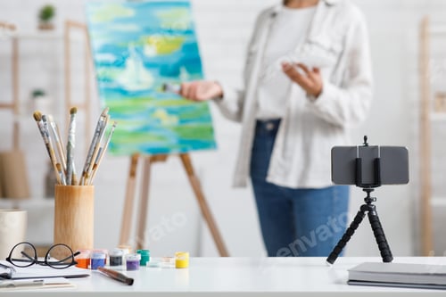 Preview: Contemporary art, hobbies and online lesson at home. Focus on smartphone, paint and brushes, african