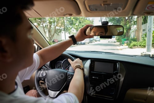 Preview: Driver Adjusting Rearview Mirror
