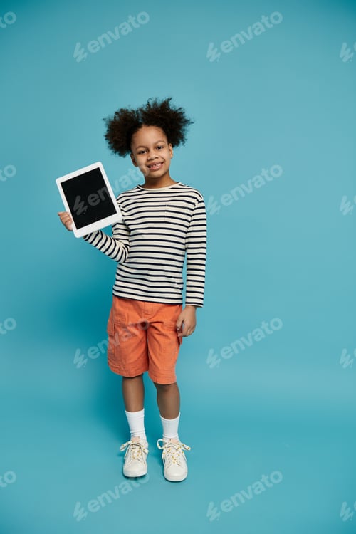 Preview: Smiling girl shows off tablet against blue background