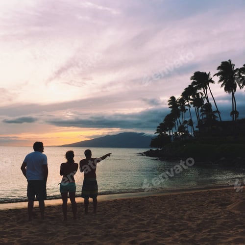 Preview: Silhouette of three people enjoying a beautiful sunset in Maui Hawaii