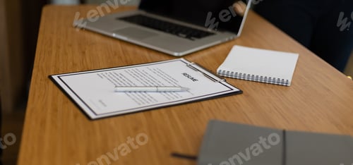 Preview: Job Application, Recruitment and Interview Ideas. Close up of resume documents on office desk.