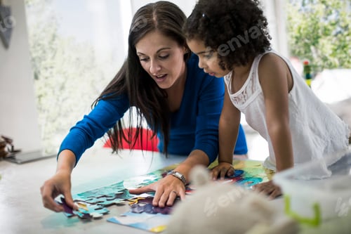 Preview: Mother and daughter playing with jigsaw puzzle