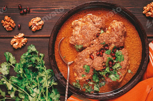 Preview: fesenjan, an Iranian dish, stewed chicken, in walnut-pomegranate sauce, in an earthen pan,