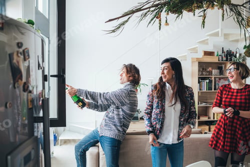 Preview: Friends celebrating with champagne in loft office