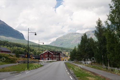 Preview: road and buildings with mountains under cloudy sky, Trysil, Norway's largest ski resort