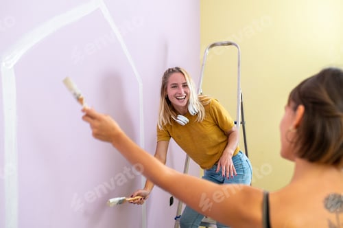 Preview: Home improvement: portrait of blonde woman painter sitting on floor while working