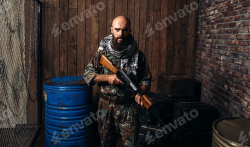 Preview: Terrorist in uniform holds kalashnikov rifle