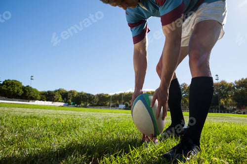 Preview: Rugby player getting ready to kick for goal against sky