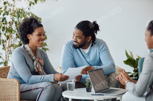 Preview: Happy black couple having meeting with their financial advisor in the office.