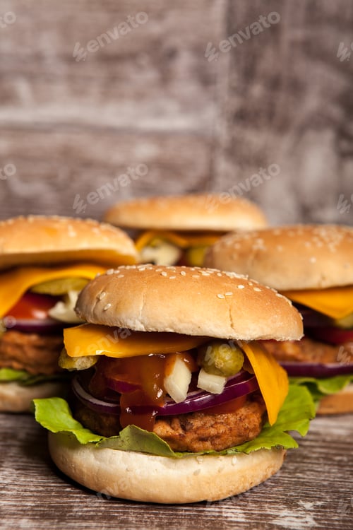 Preview: Delicious tasty burgers on wooden background