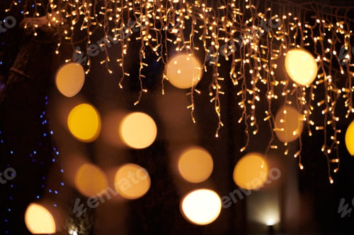 Preview: Yellow lights bokeh from christmas holiday garlands, blurred festive background, abstract lights