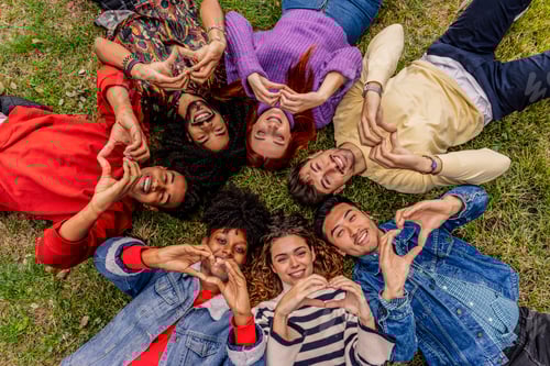 Preview: Friends Forming Heart Shapes Lying on Grass