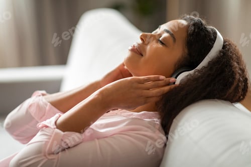 Preview: Peaceful Moment for Woman with Headphones on Couch at Home