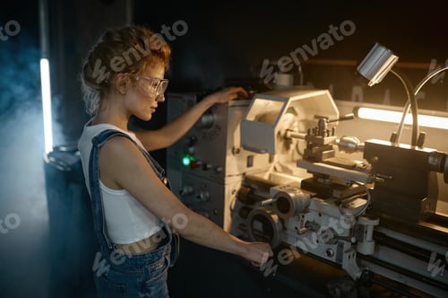 Preview: Young blond woman mechanical engineer working on lathe machine