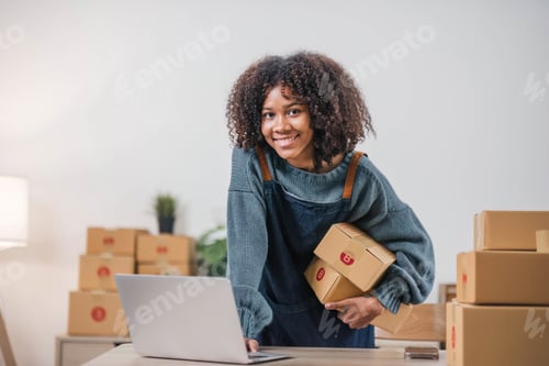 Preview: Startup small business entrepreneur SME, asian woman packing cloth in box. Portrait young Asian