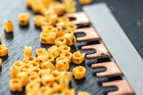 Preview: Cable markers scattered on the table, macro shot.