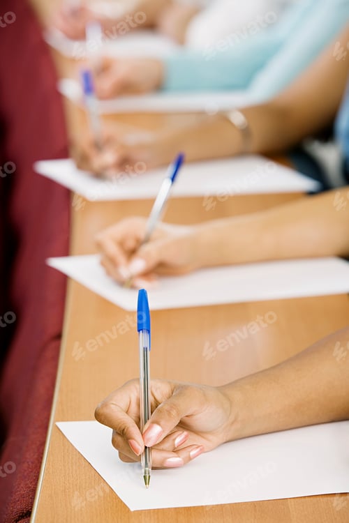 Preview: cropped shot of students taking notes during lecture