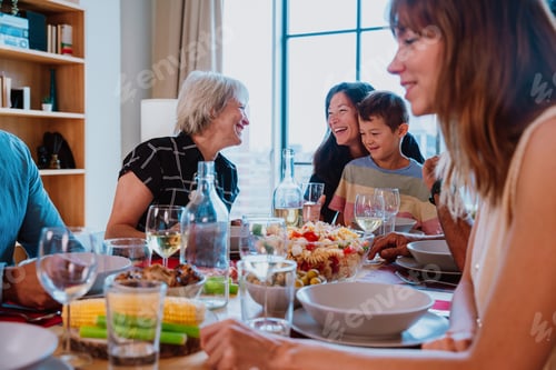 Preview: Family and friends reunion at home. Multi-generational family gathering having lunch at home
