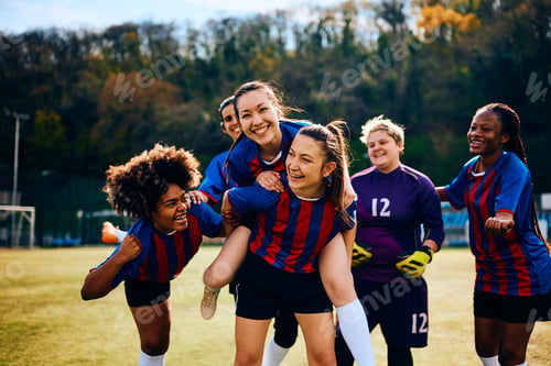 Preview: Multiracial women's soccer team having fun and celebrating after a victory.