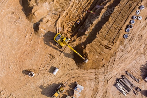 Preview: In excavator digs a trench for the laying of underground storm sewer pipes on a construction site
