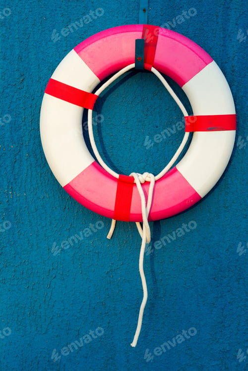 Preview: life belt hanging on blue wall