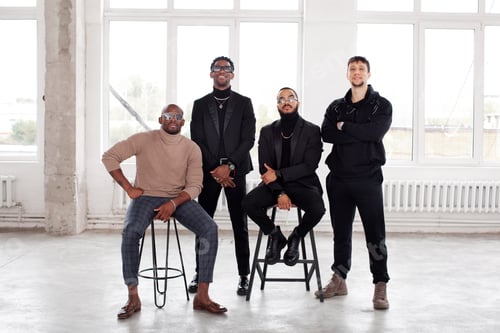 Preview: Four stylish men posing in front of windows