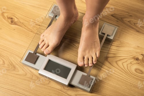 Preview: Female feet on the modern digital weighing scale