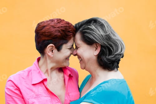 Preview: Senior gay lesbian couple enjoy tender moment outside - LGBTQ mature female lovers smiling outdoor