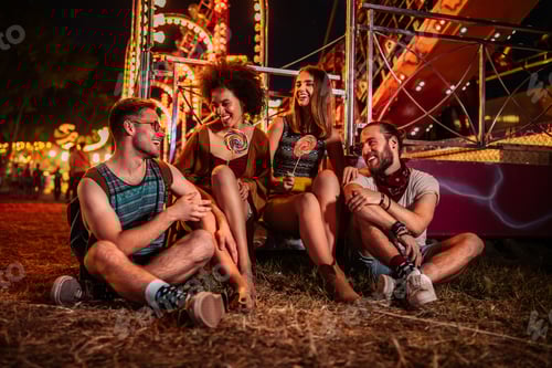Preview: Friends Enjoying Lollipops at the Fair at Night