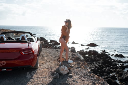 Preview: Attractive woman traveling by car near the ocean
