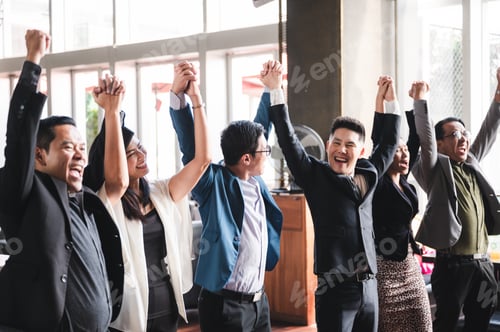 Preview: large business team showing unity with their hands together, business team celebrating