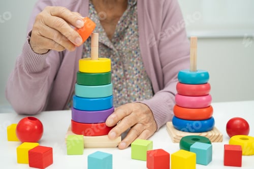 Preview: Asian elderly woman patient learn practical motor game skills rehabilitation.