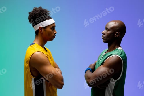 Preview: Image of two diverse basketball players facing each other on purple to green background