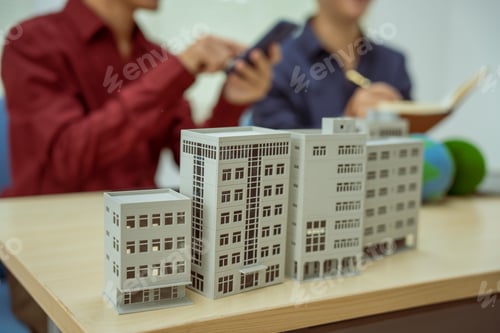 Preview: Two businessmen work at desks office,discussing city clean energy strategies global technology