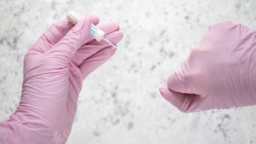 Preview: Feminine Hygiene Product with Gloved Hands on White