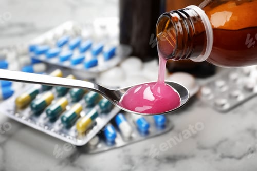Preview: Pouring cough syrup from bottle into spoon on blurred background, closeup