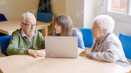 Preview: Senior Adults with Young Woman Use Laptop