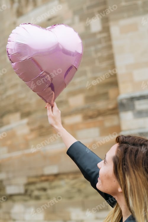 Preview: Woman holding a heart balloon