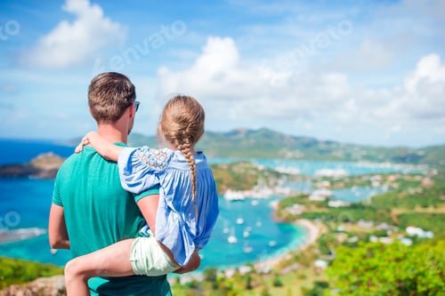 Preview: Family of dad and little kid enjoying the view of picturesque English Harbour at Antigua in