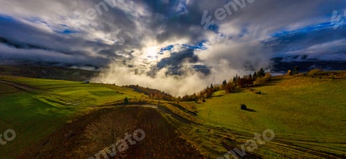 Preview: Fly over landscapes of green hills under a layer of white and fluffy clouds