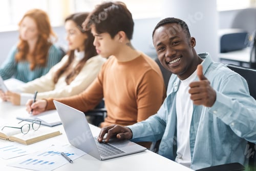 Preview: Group of international people using laptops in coworking