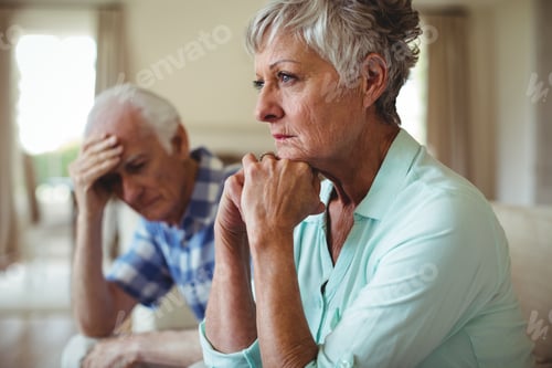 Preview: Upset senior couple relaxing on sofa