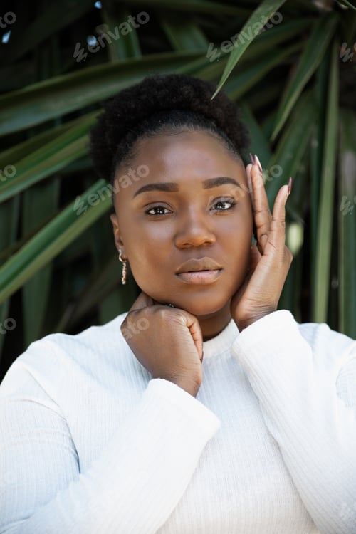 Preview: Black woman near green plant