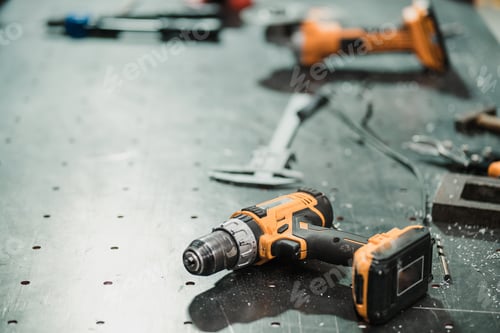 Preview: Various Power Tools on a Metal Work Surface