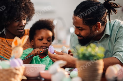 Preview: Focus on a purple egg while the whole african american family decorate it