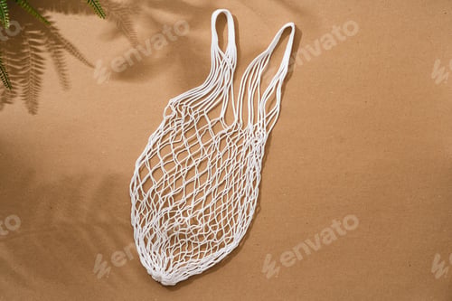 Preview: Empty string reusable bag on paper background, top view