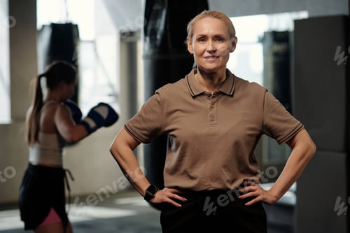 Preview: Happy mature blond female trainer